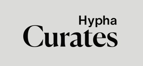 Text displaying 'Hypha Curates' with Hypha above Curates on a gray background.
