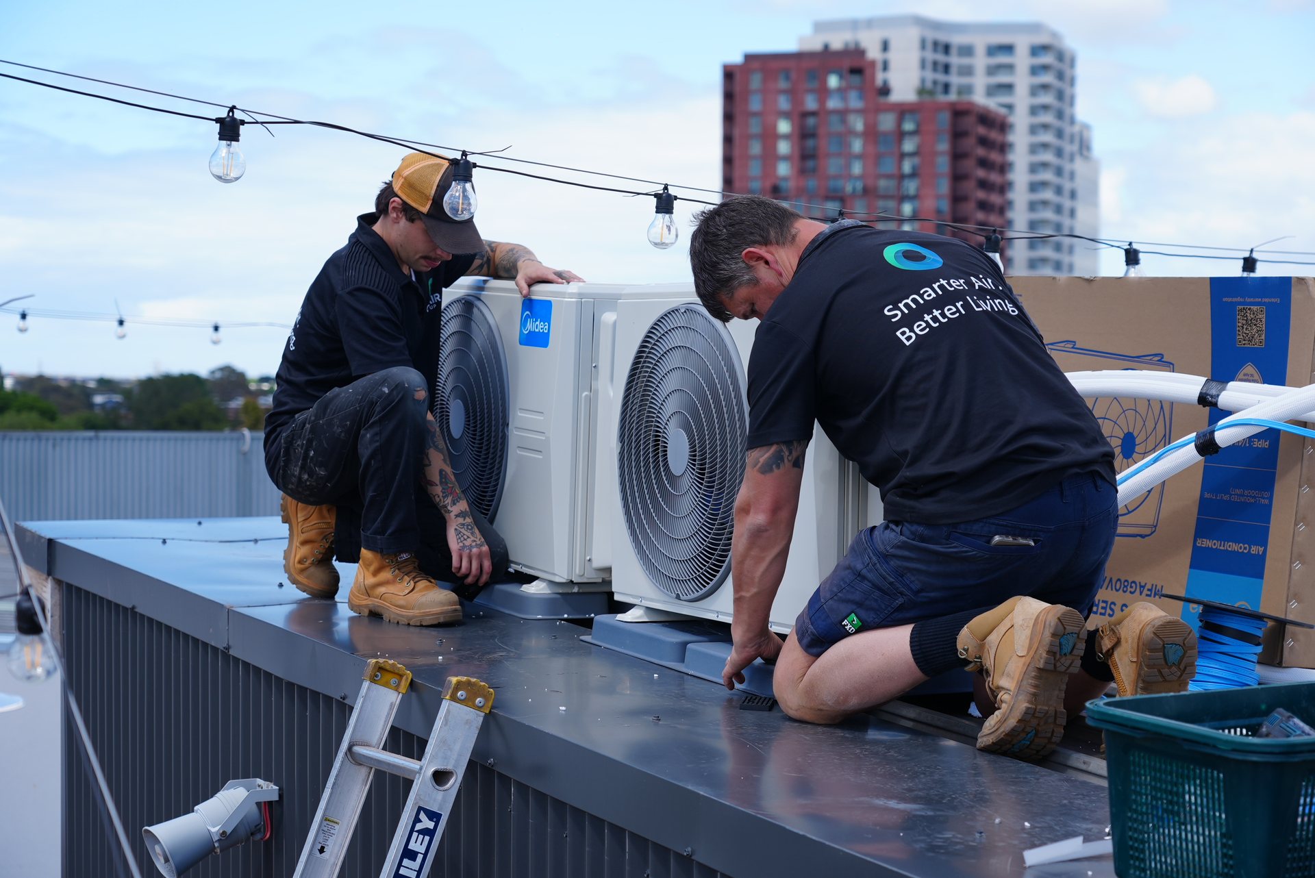 Two outdoor split-system condenser units installed side by side on a Melbourne rooftop by Oz Air Group