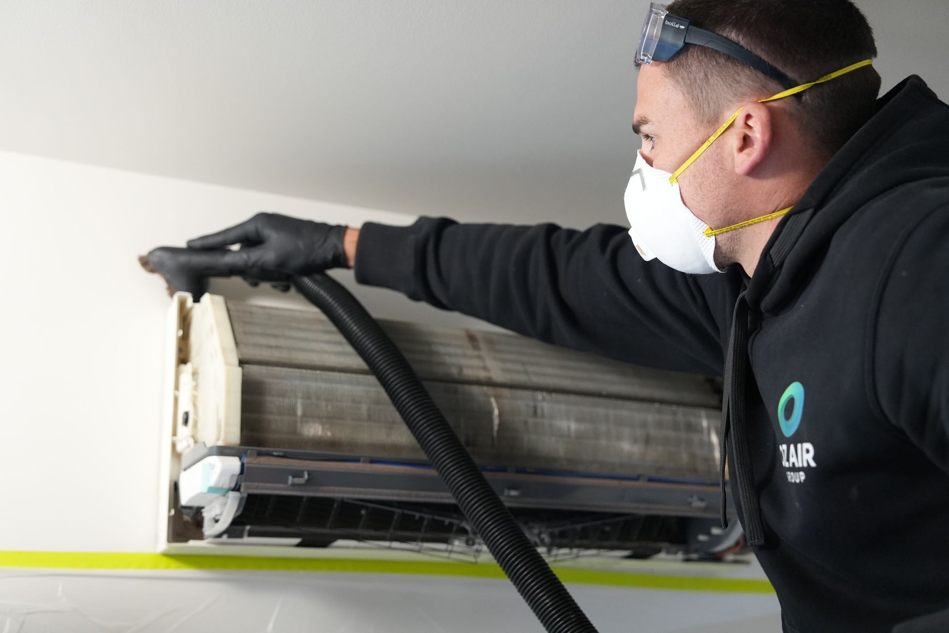 Oz Air Group technician deep cleaning a split system air conditioner in Melbourne