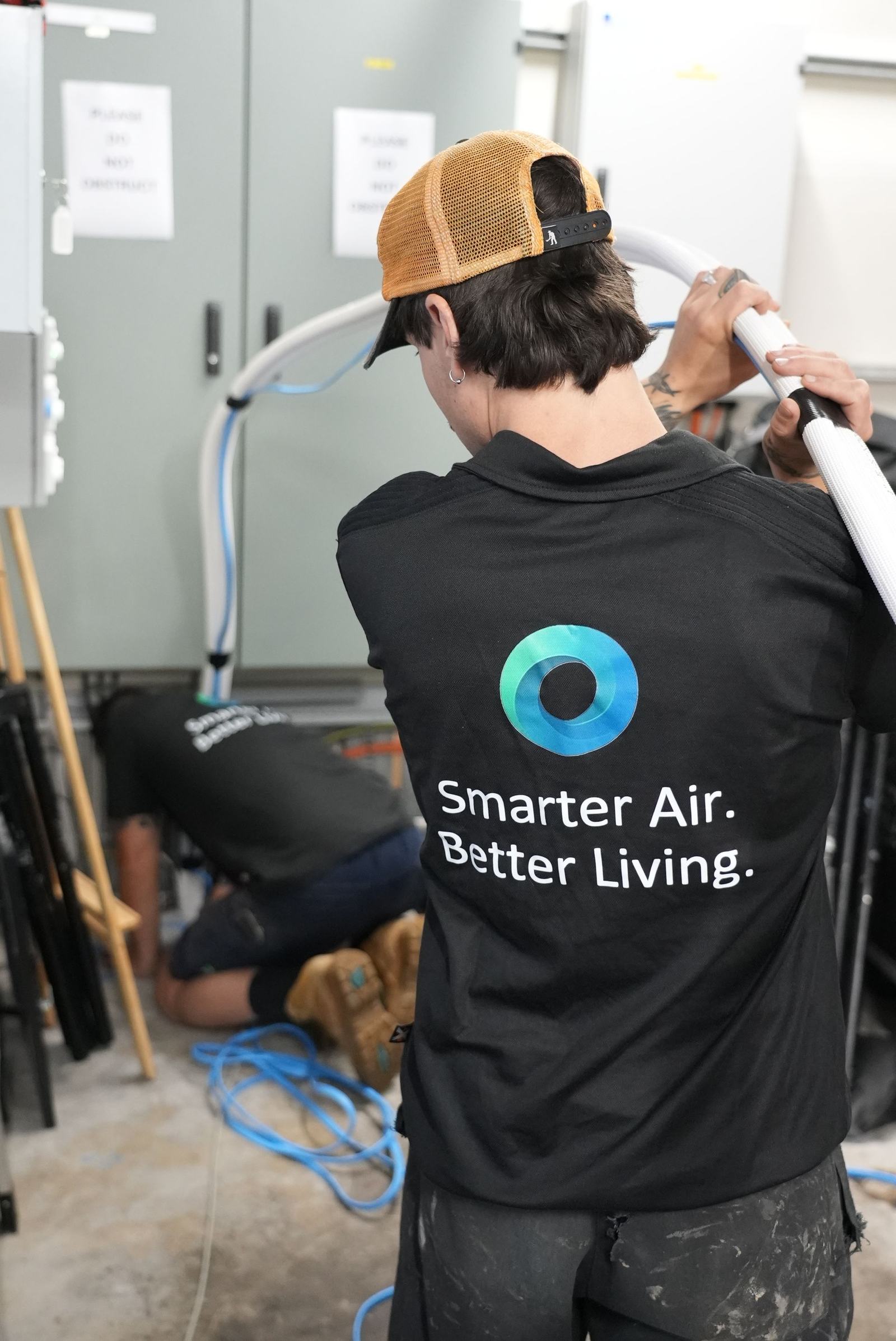 Oz Air Group technician servicing an indoor split system unit in Melbourne
