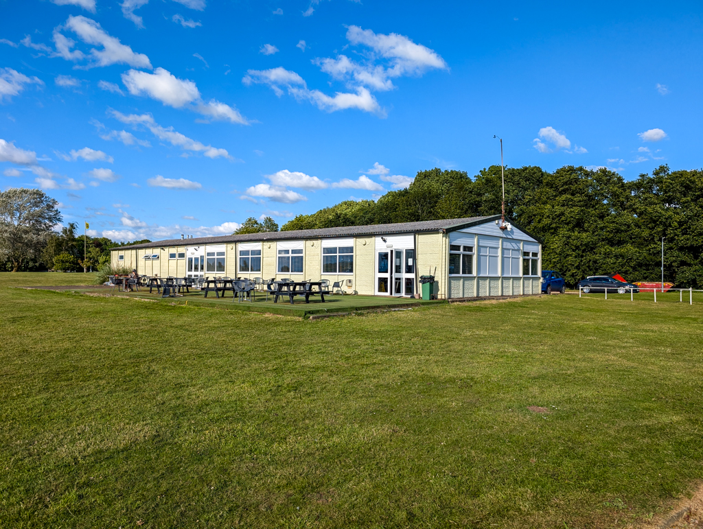 Main clubhouse building with outdoor picnic area.