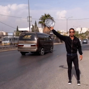 Real footage of a person promoting his coffee in the streets of amman part of duwar immersive experience.