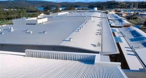 Building with large white metal roof.