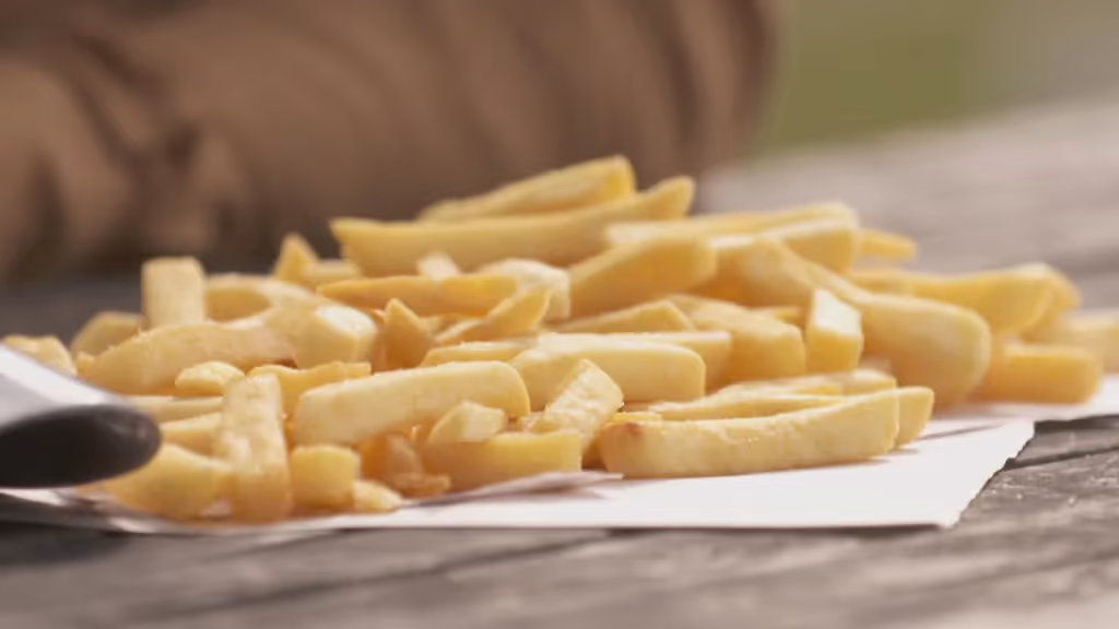Hot chips poured on a table.