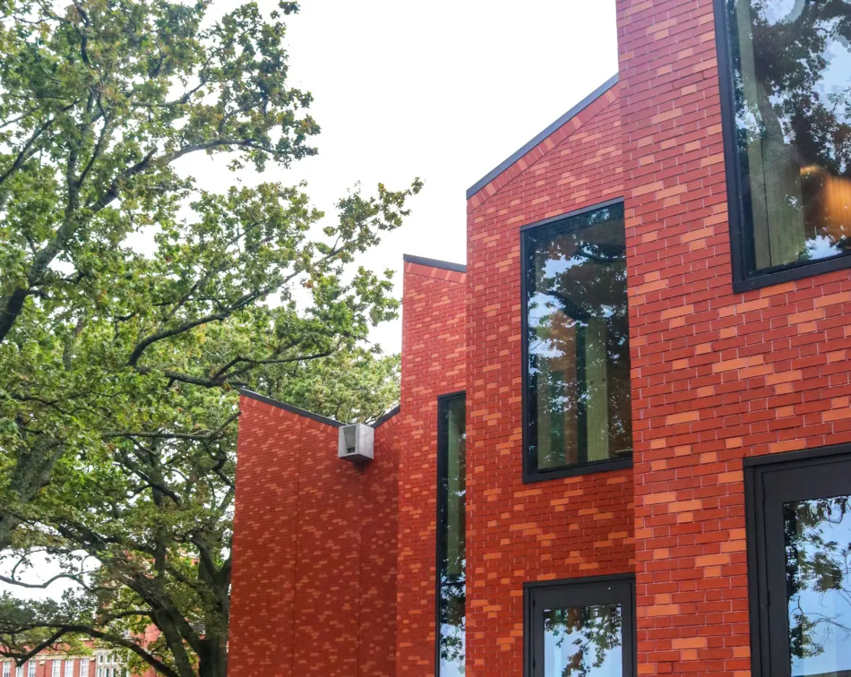 Exterior view of King’s College Performing Arts Centre in Auckland, featuring warm-toned brick cladding and contemporary architectural lines.