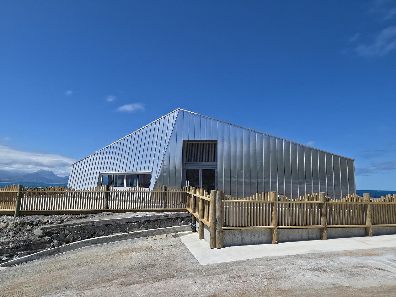 A boat-hull inspired hospitality venue in Kaikōura, featuring a resilient facade designed by Oculus to withstand extreme marine conditions.