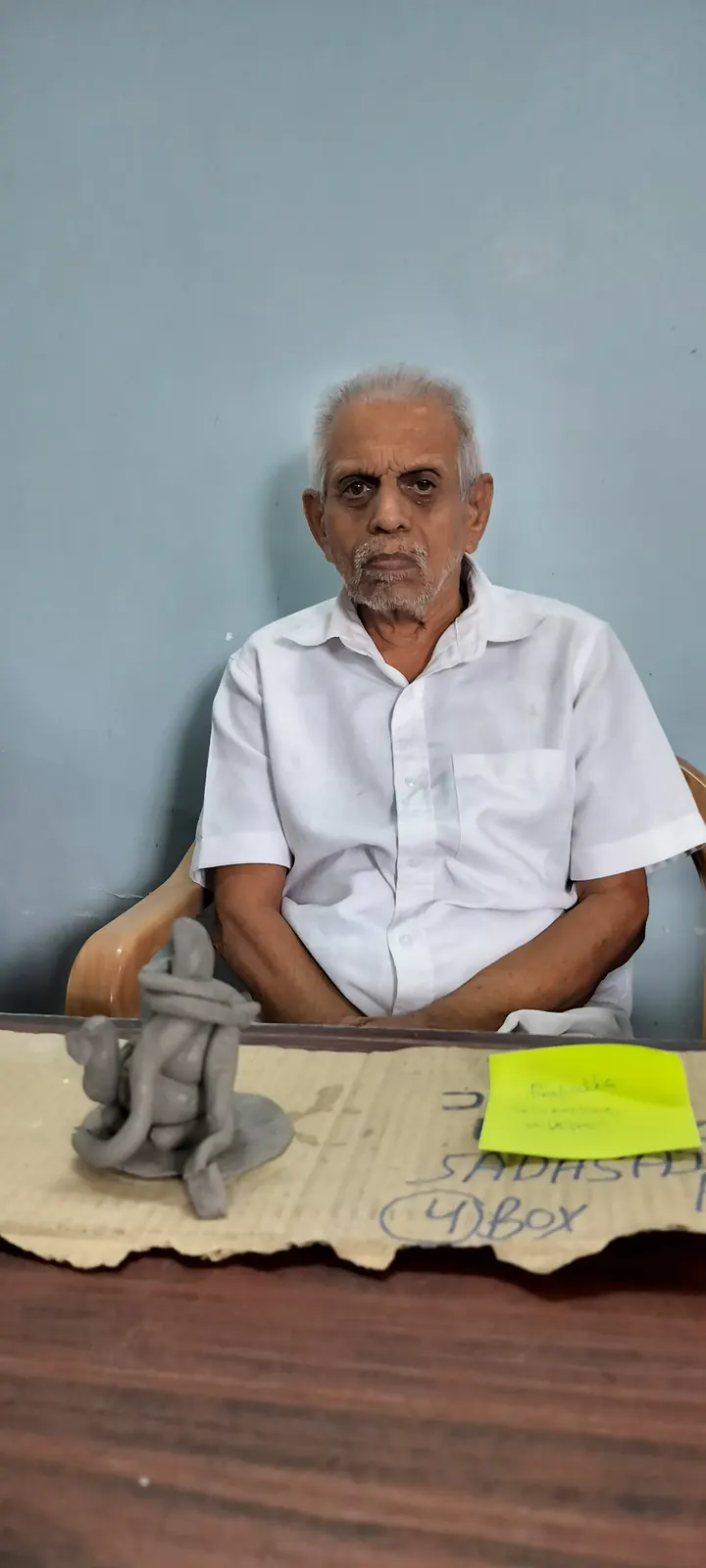 A resident proudly showing the Ganesha idol he made