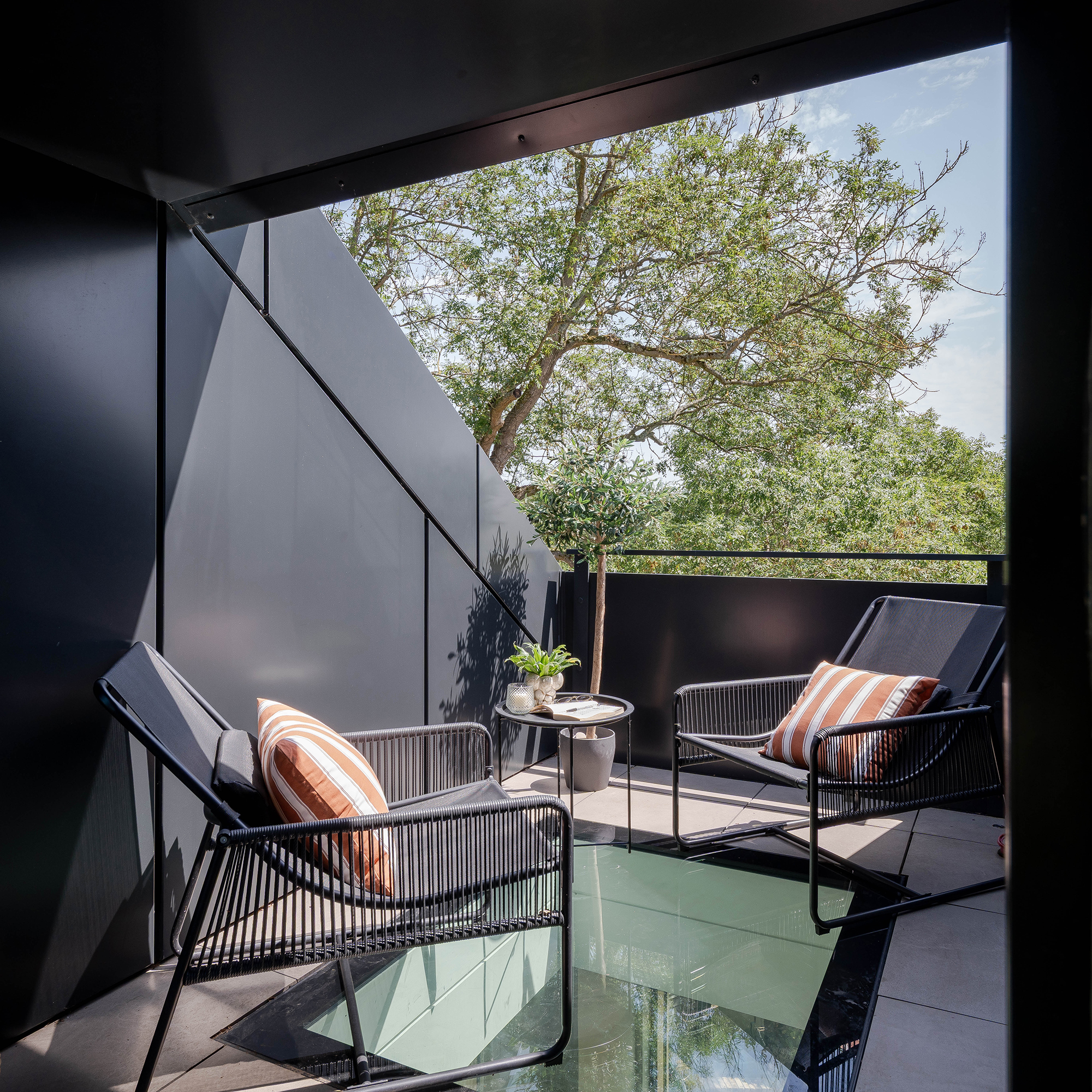 Large balcony terrace to contemporary home in Essex Green Belt with glass light box feature and zinc cladding