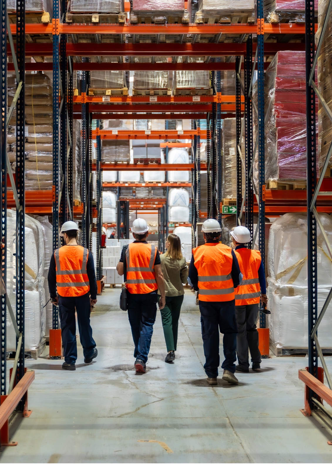 Warehouse staff walking through racking aisles
