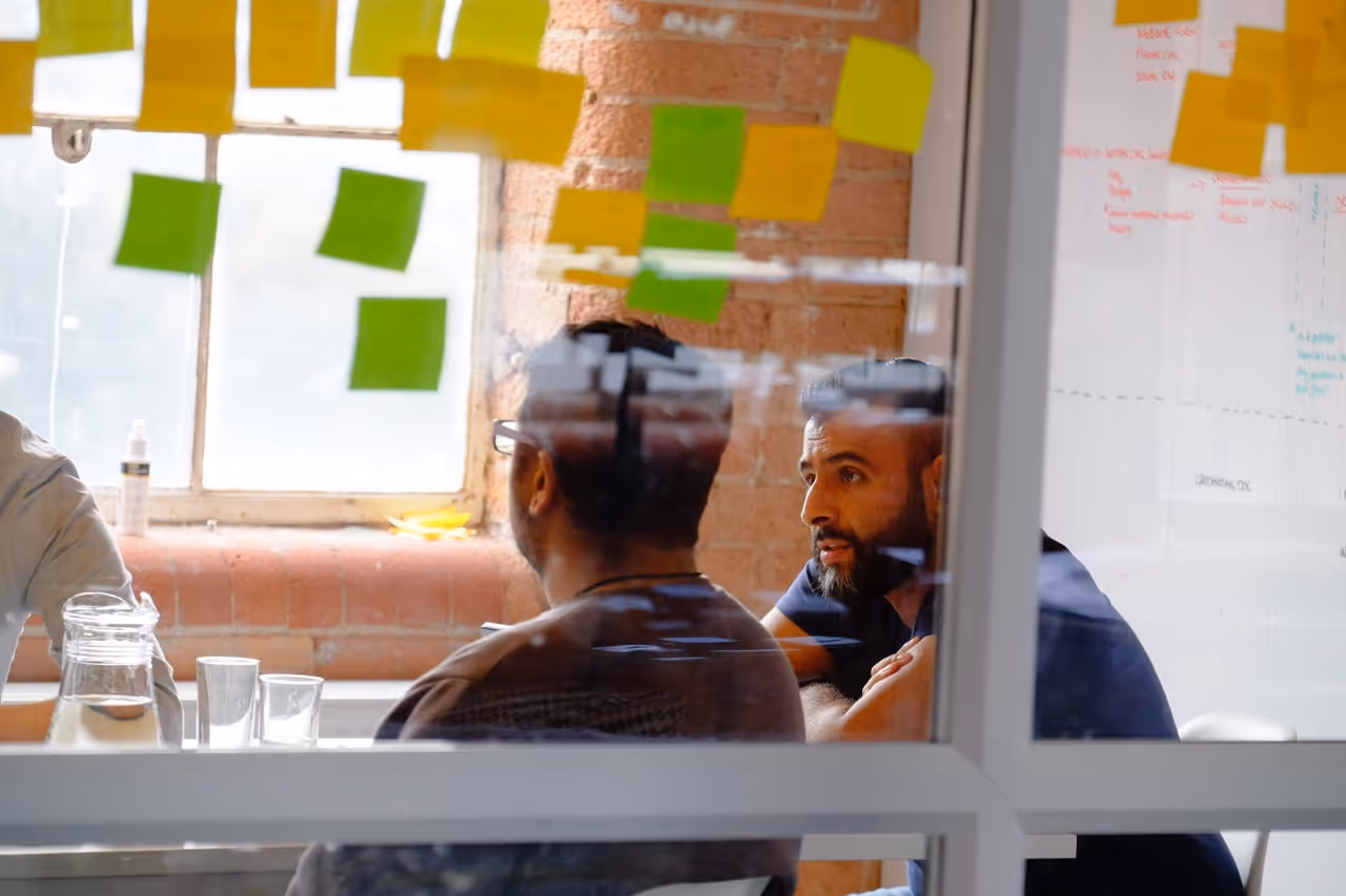 2 men talking around a table