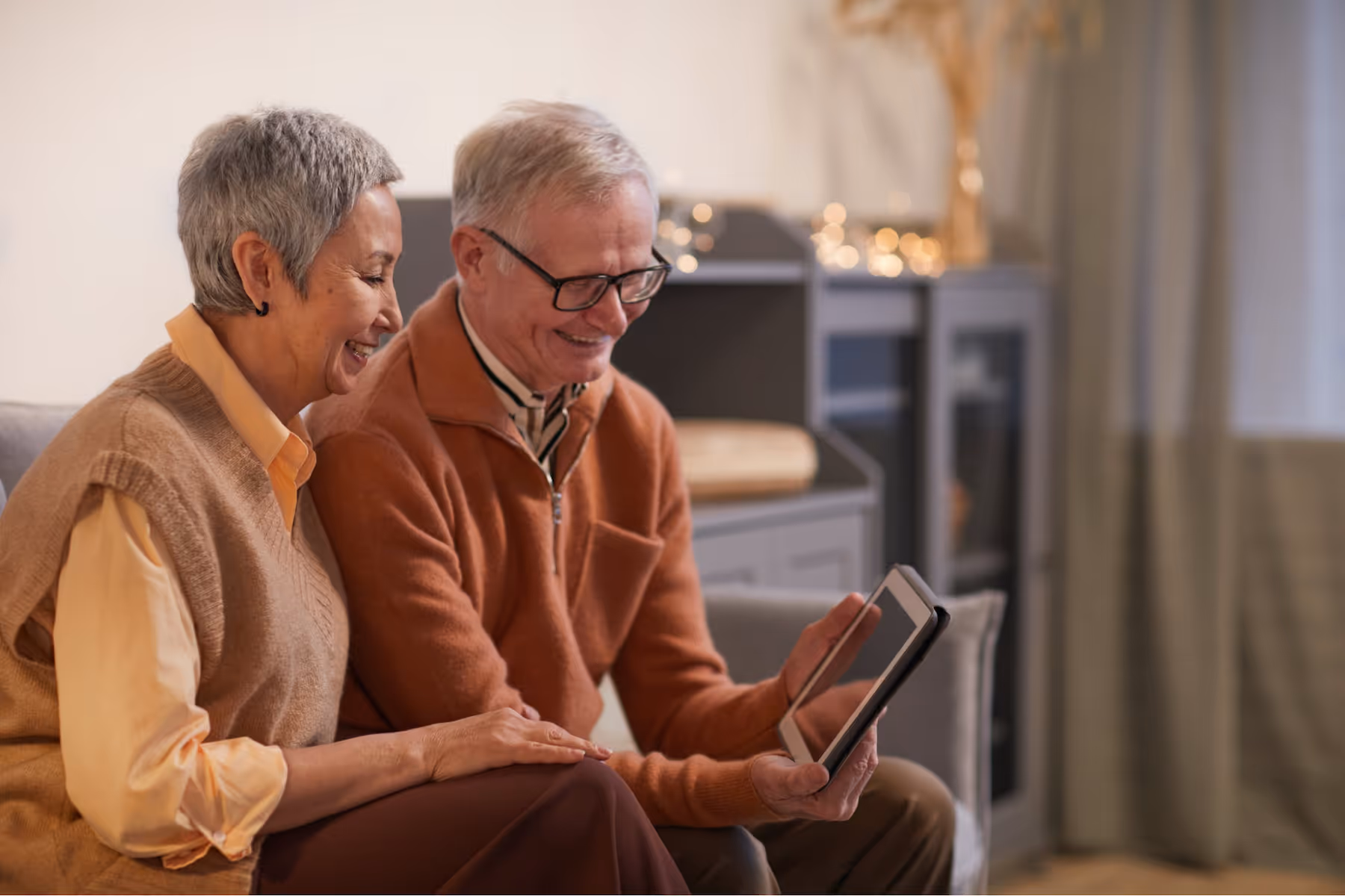 Elderly couple looking at a tablet