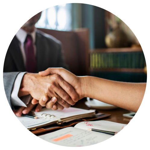 Business handshake over documents at a professional services firm