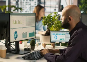 Analyst reviewing data dashboards on a monitor