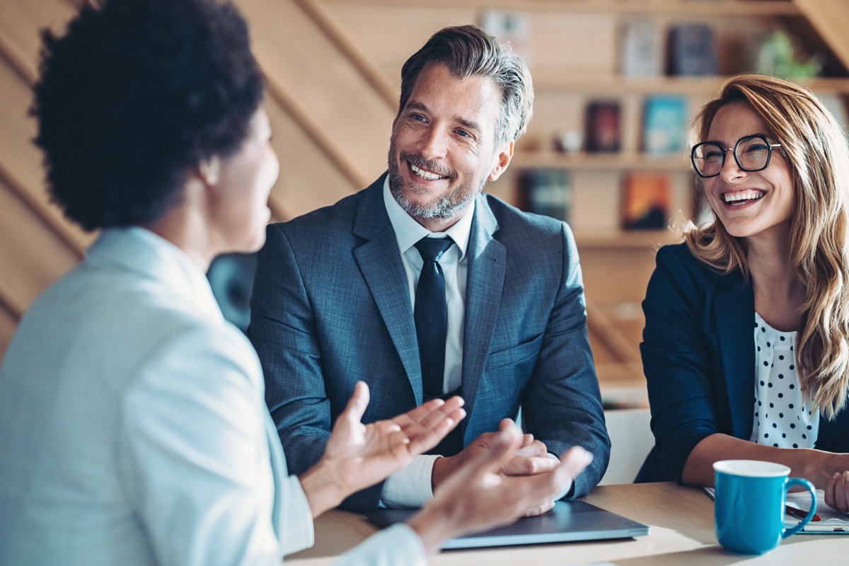 Consultants in a lively discussion with a client around a table