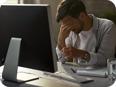 Team working at a shared table while a colleague takes a call