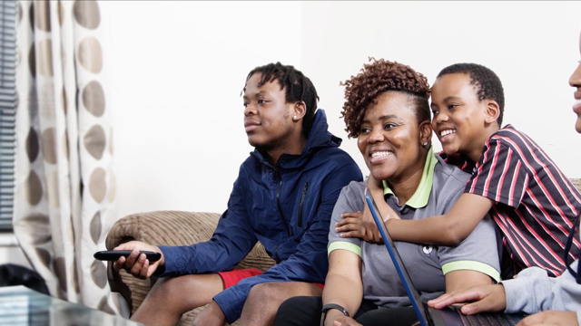 A group of people sitting on a couchAI-generated content may be incorrect.