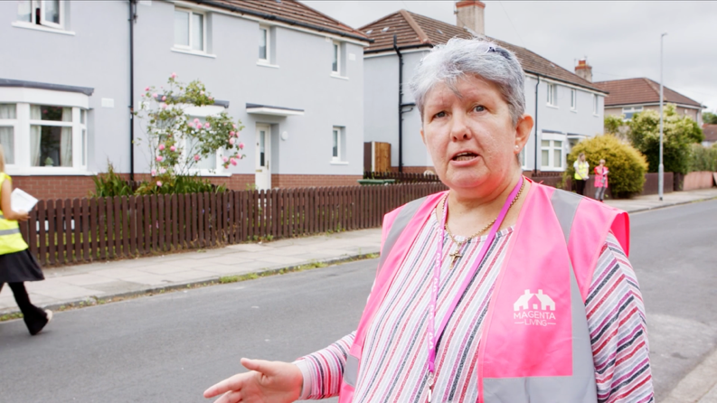 A person in a pink vestAI-generated content may be incorrect.