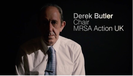 A person in a white shirt and tie staring down camera for a medical case study film.