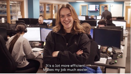 A person smiling at camera for a case study film about technology.