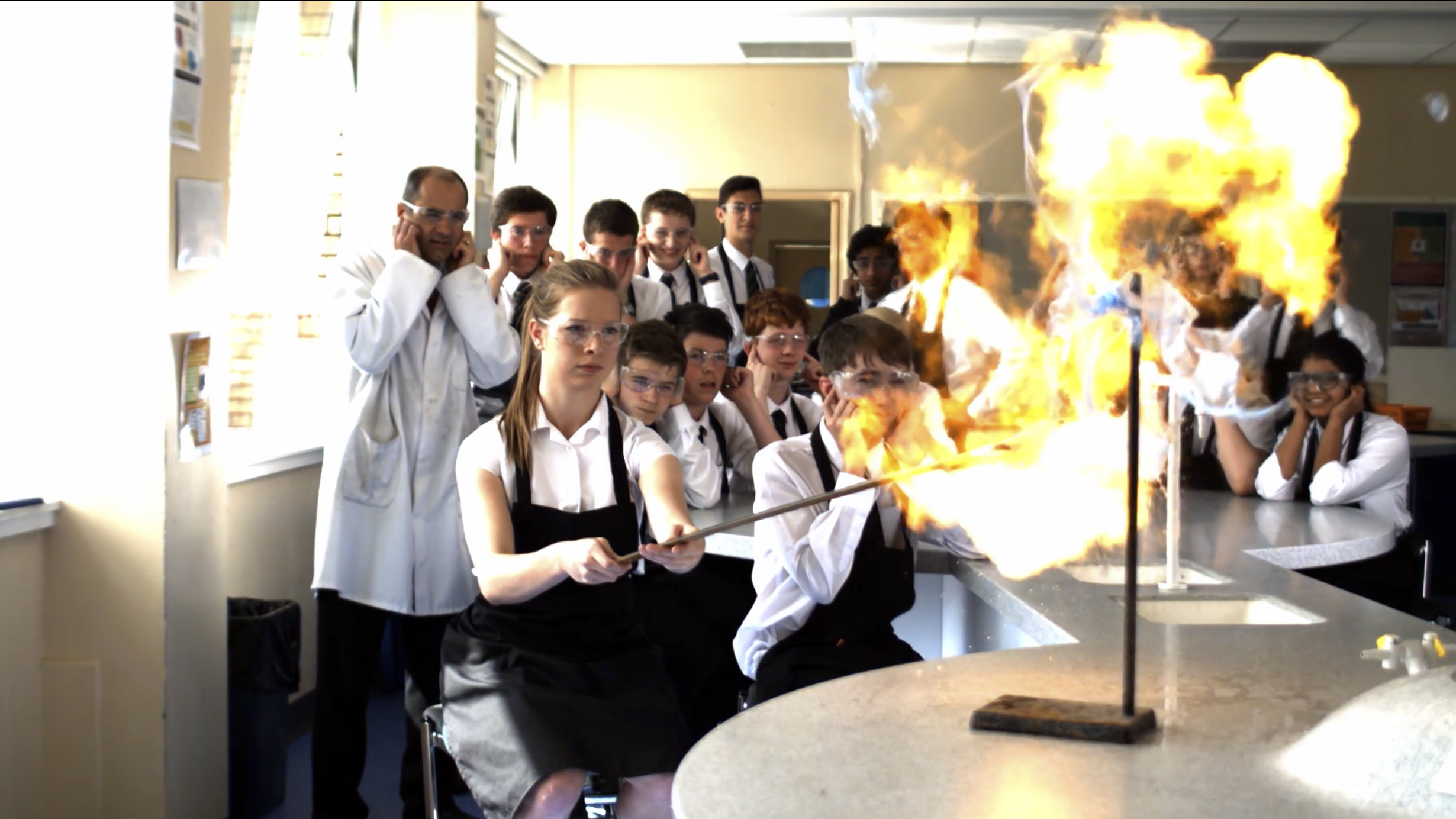 Science educationfilm film still of students and an explosive science experiment.