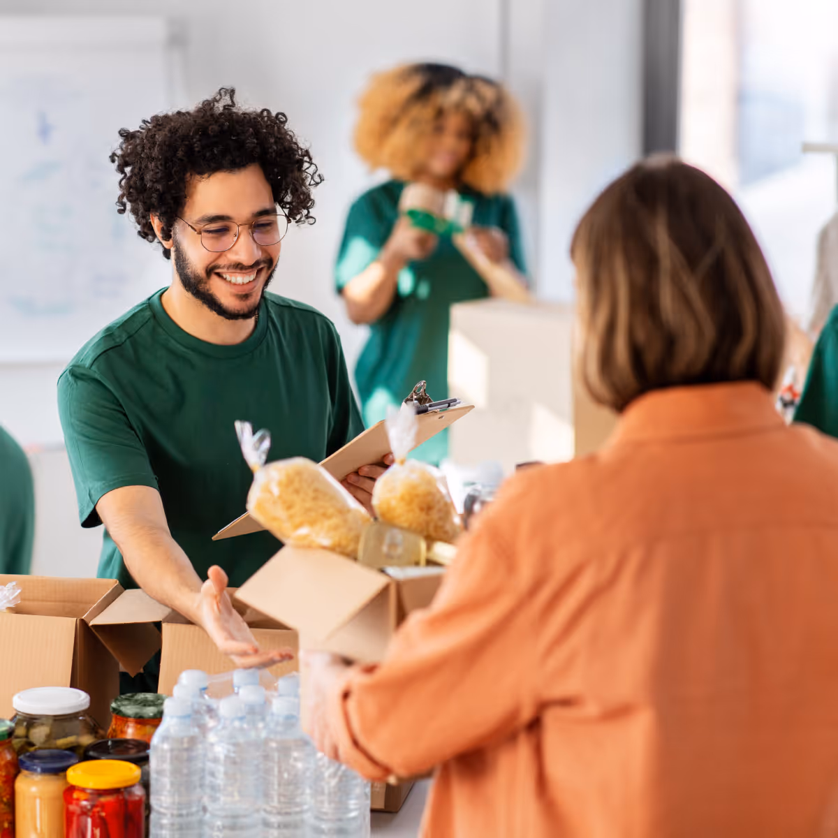 Volunteers packing food in donation boxes