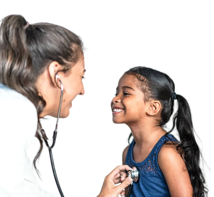 Female doctor using a stethoscope to listen to the chest of a smiling young girl with a ponytail.