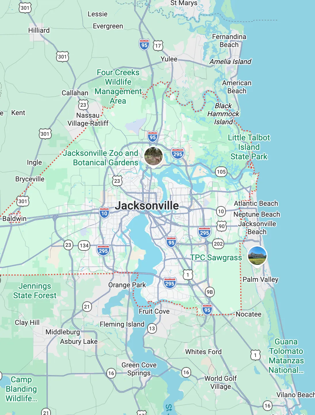 Smiling female doctor in white coat interacting with a young girl wearing hair clips and a pink sweater.