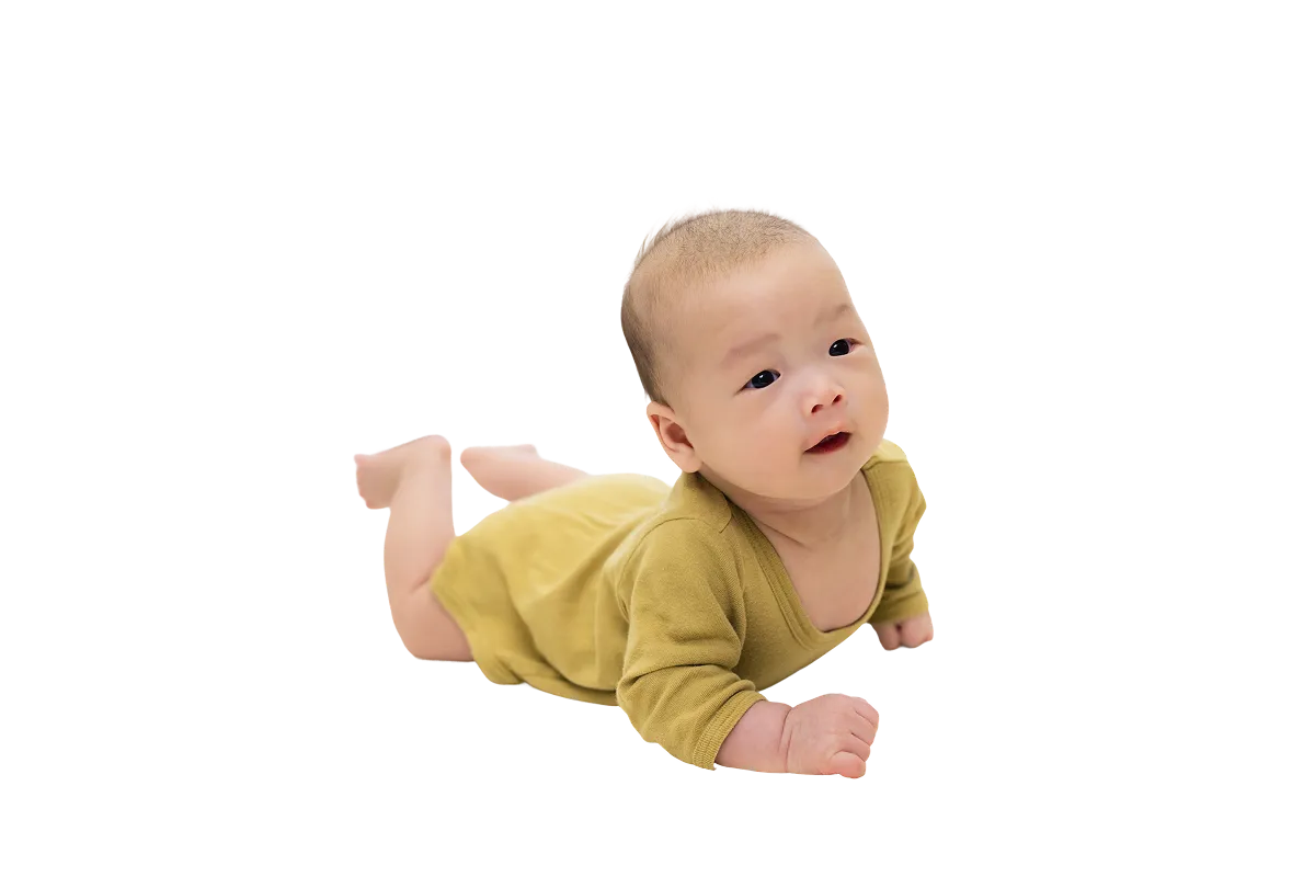 Baby lying on their stomach wearing a mustard yellow outfit.