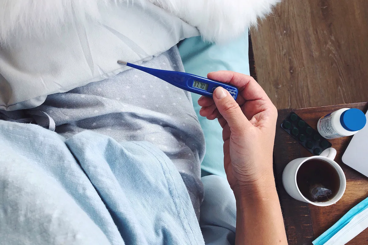 Woman holding a thermometer