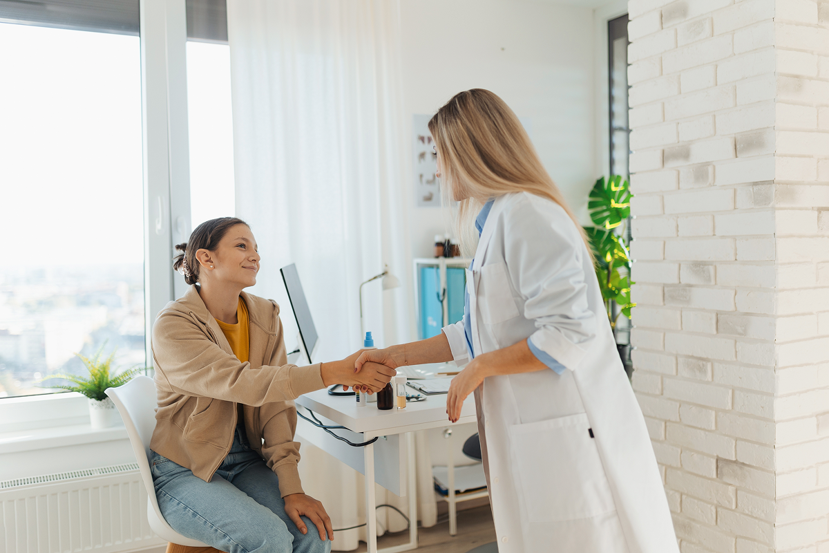 Teen patient greeting a doctor