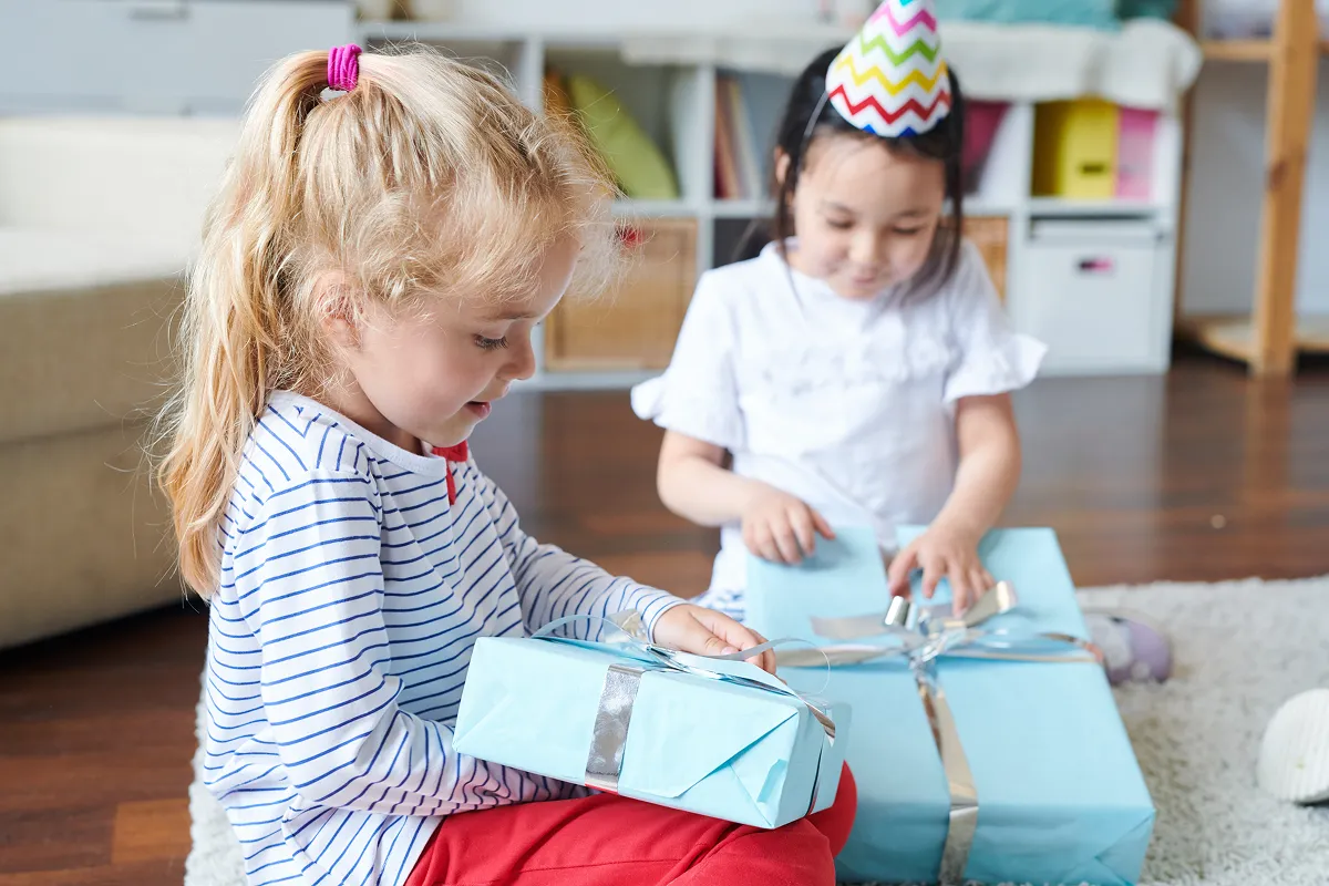Toddlers opening gifts