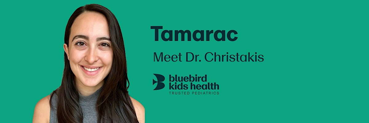 Expectant couple embracing and smiling on a Bluebird Kids Health event banner for the Tamarac practice