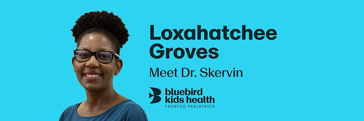 Expectant couple embracing and smiling on a Bluebird Kids Health event banner for the Loxahatchee practice