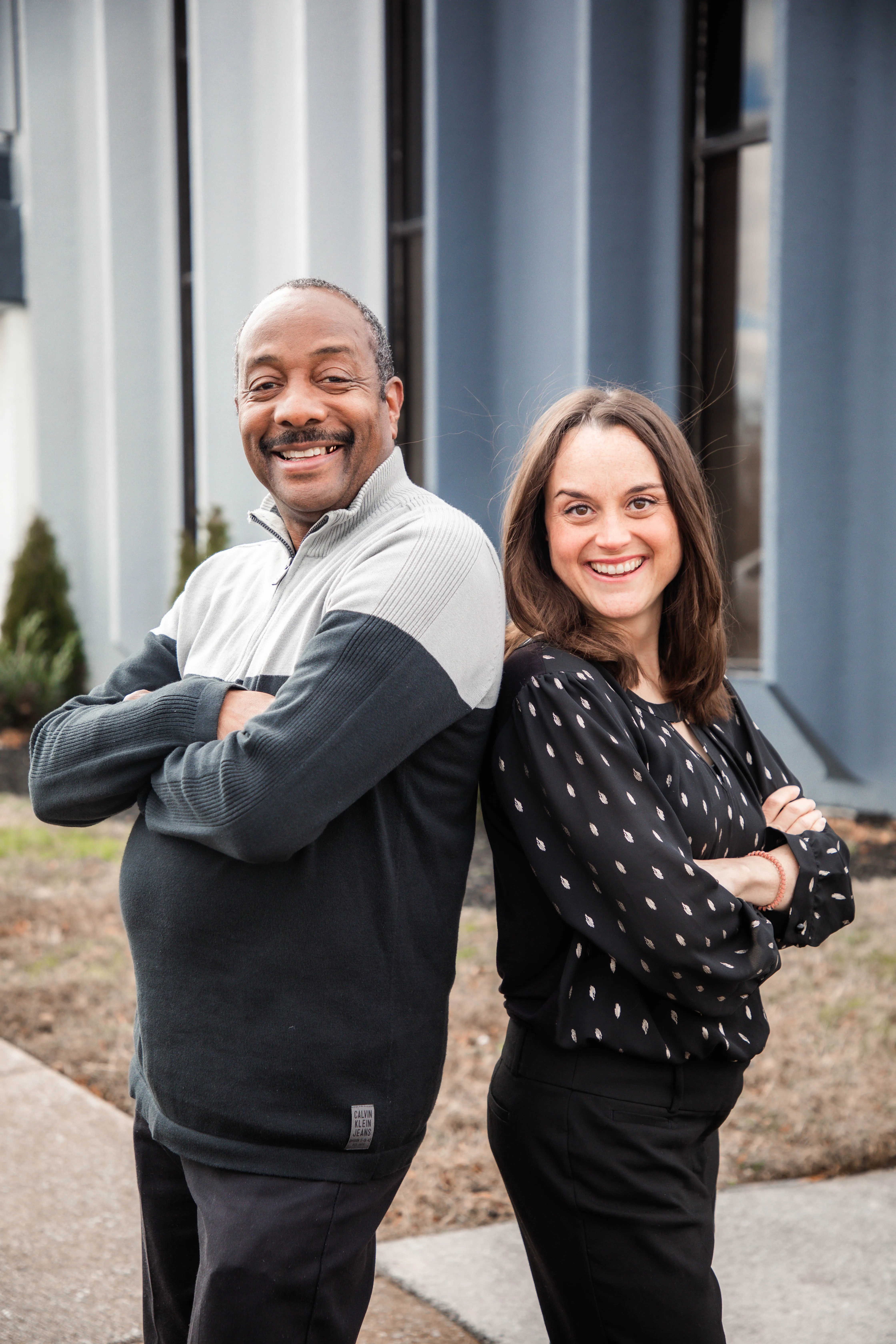 Two people smiling back to back