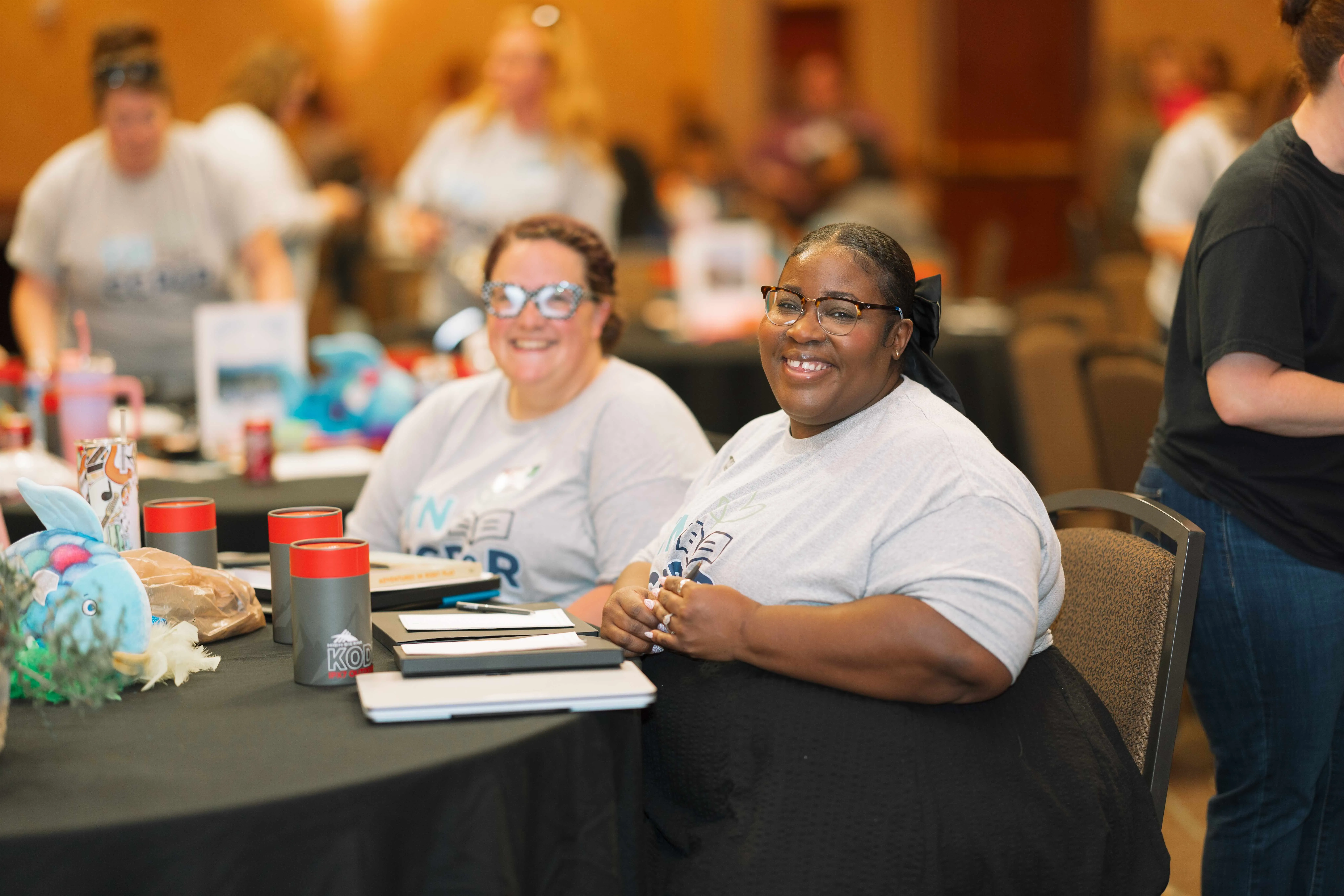 Two people smiling at table