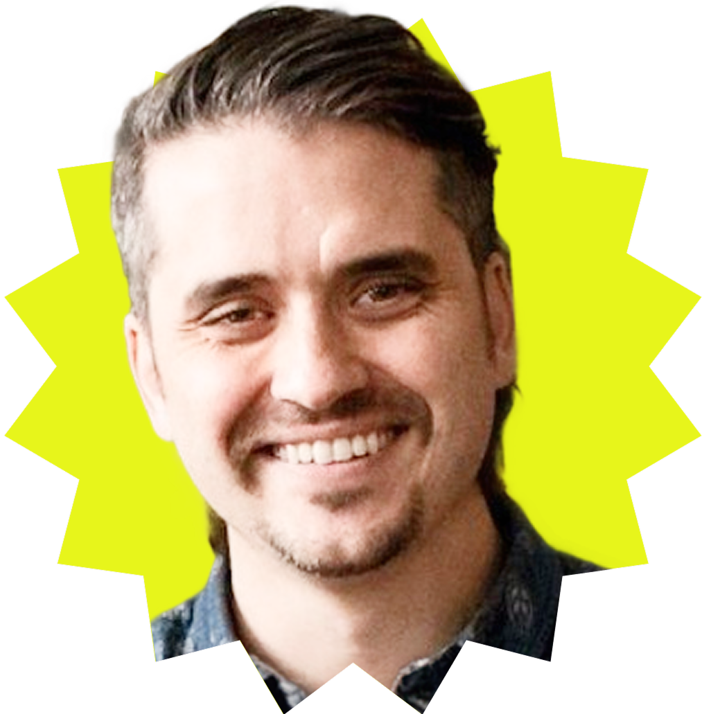 A headshot of Derek Nelson in front of a yellow background.