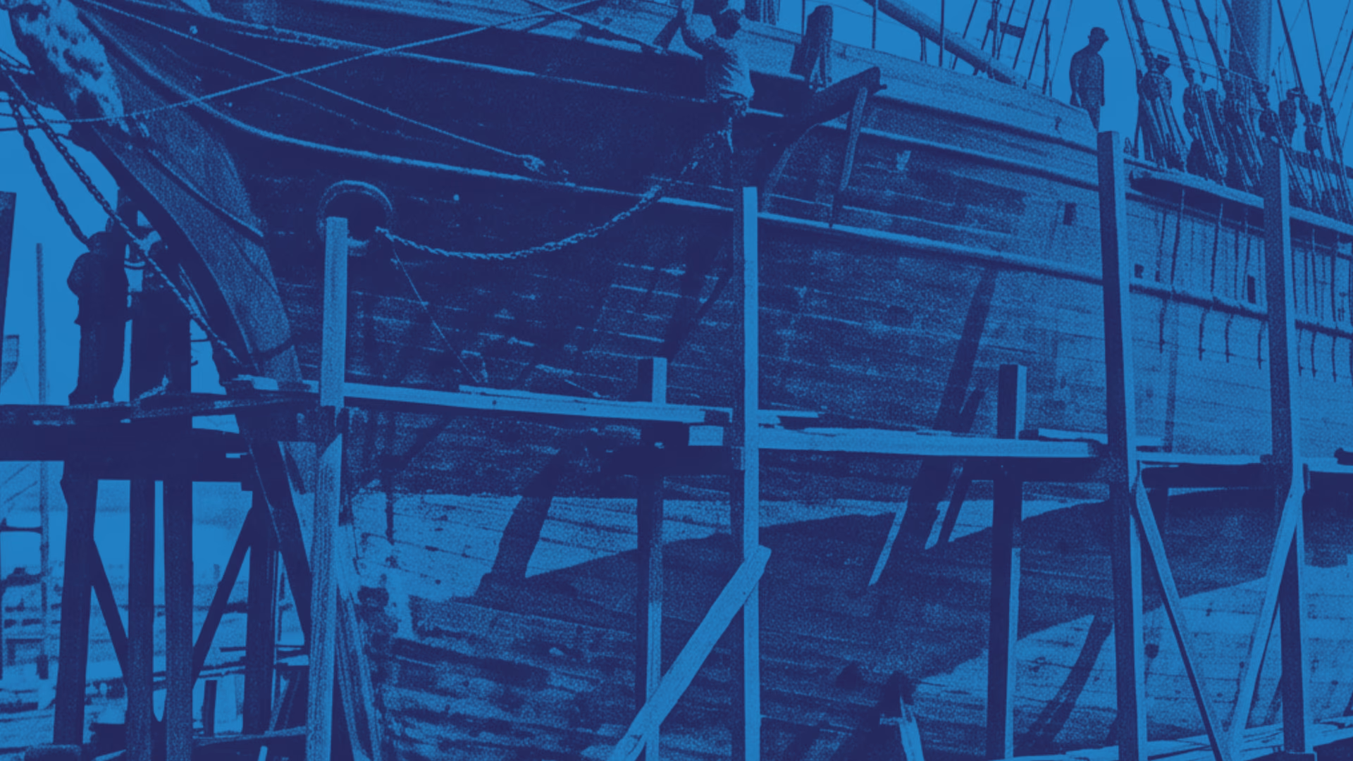 Shipwrights at work on the hull of a wooden sailing ship in dry dock, surrounded by scaffolding and rigging.
