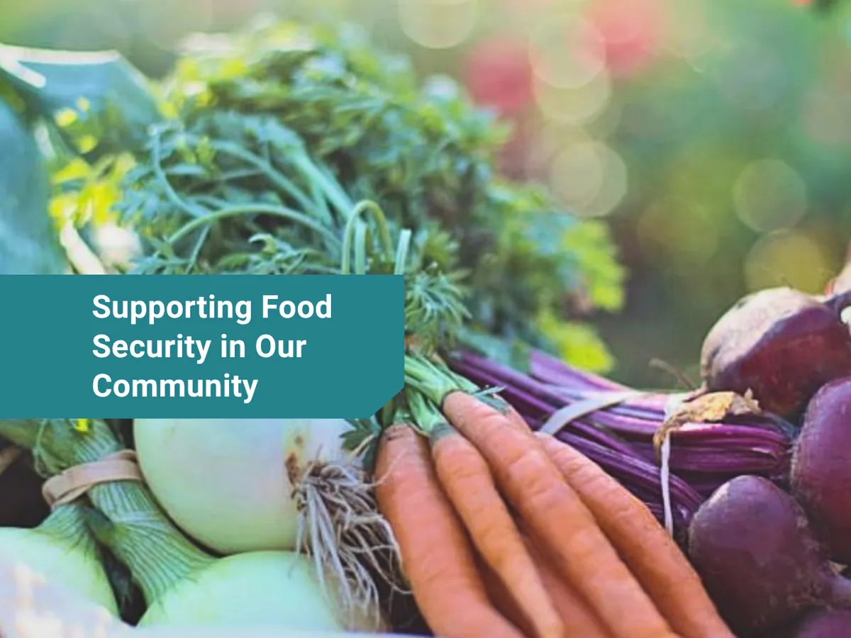 Structured post graphic: Supporting Food Security in Our Community, over a photo of fresh vegetables.