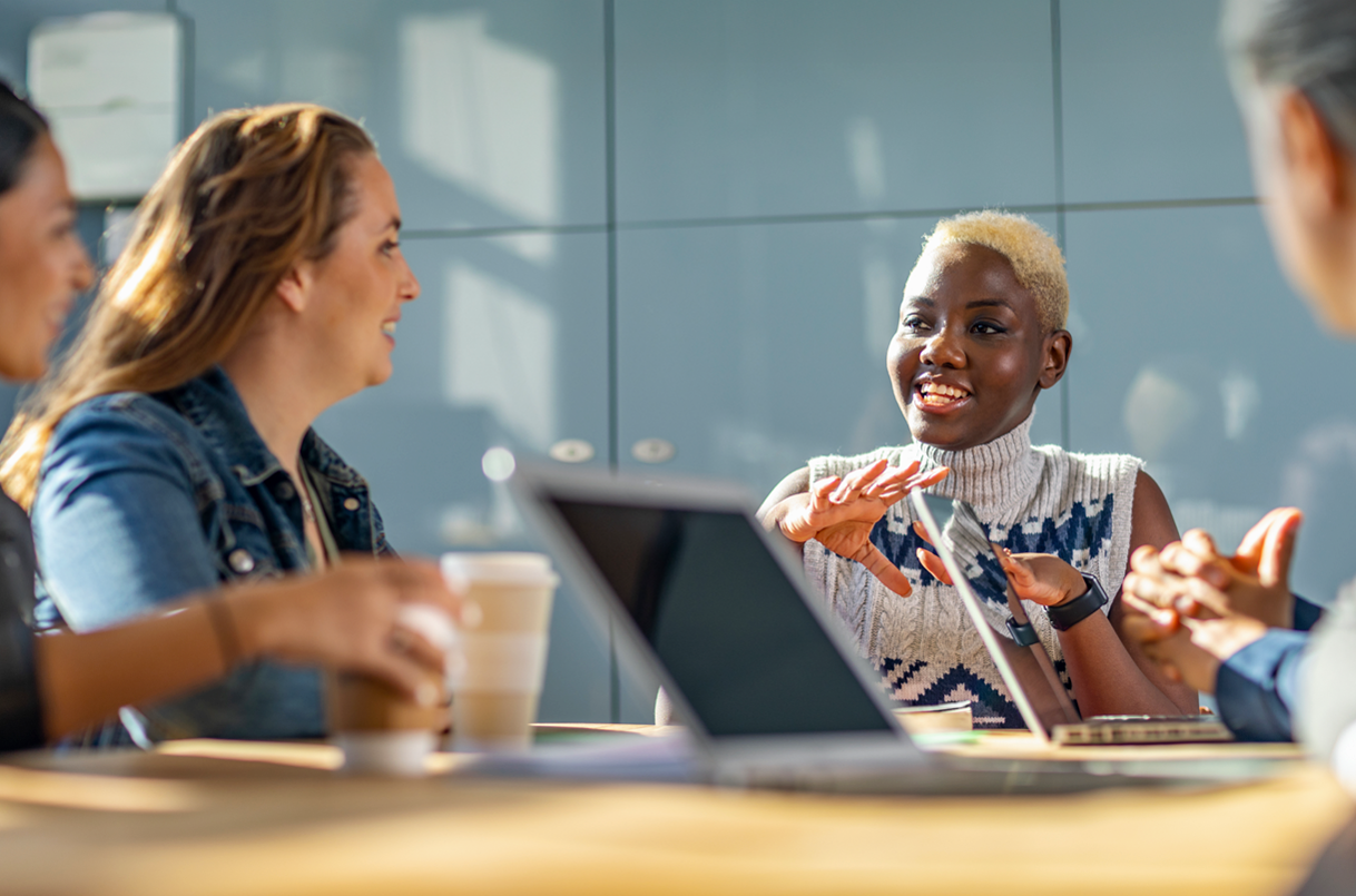 Team in training sitting around table.