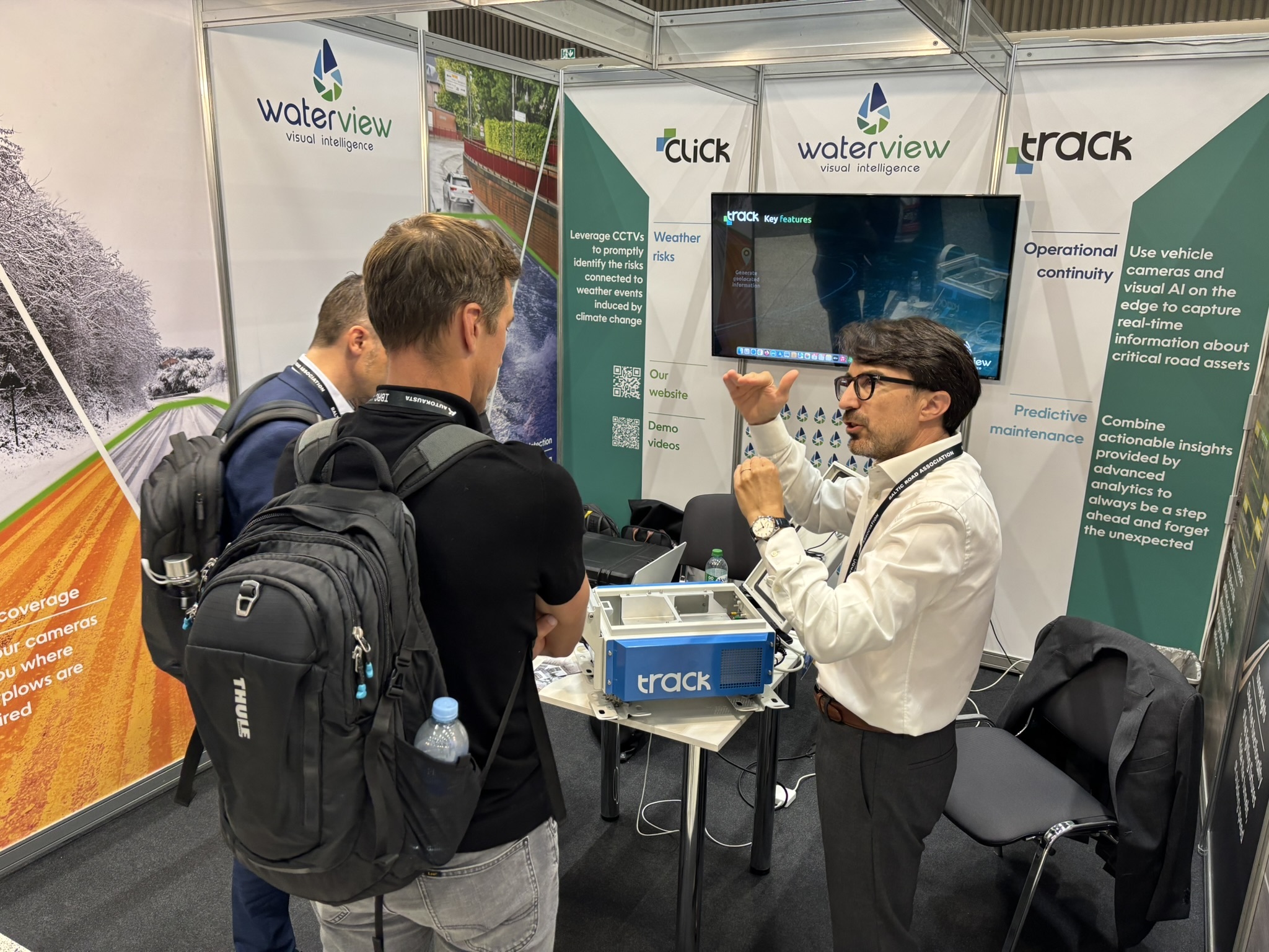 WaterView employee presenting the kit TraCK to two potential clients at a conference