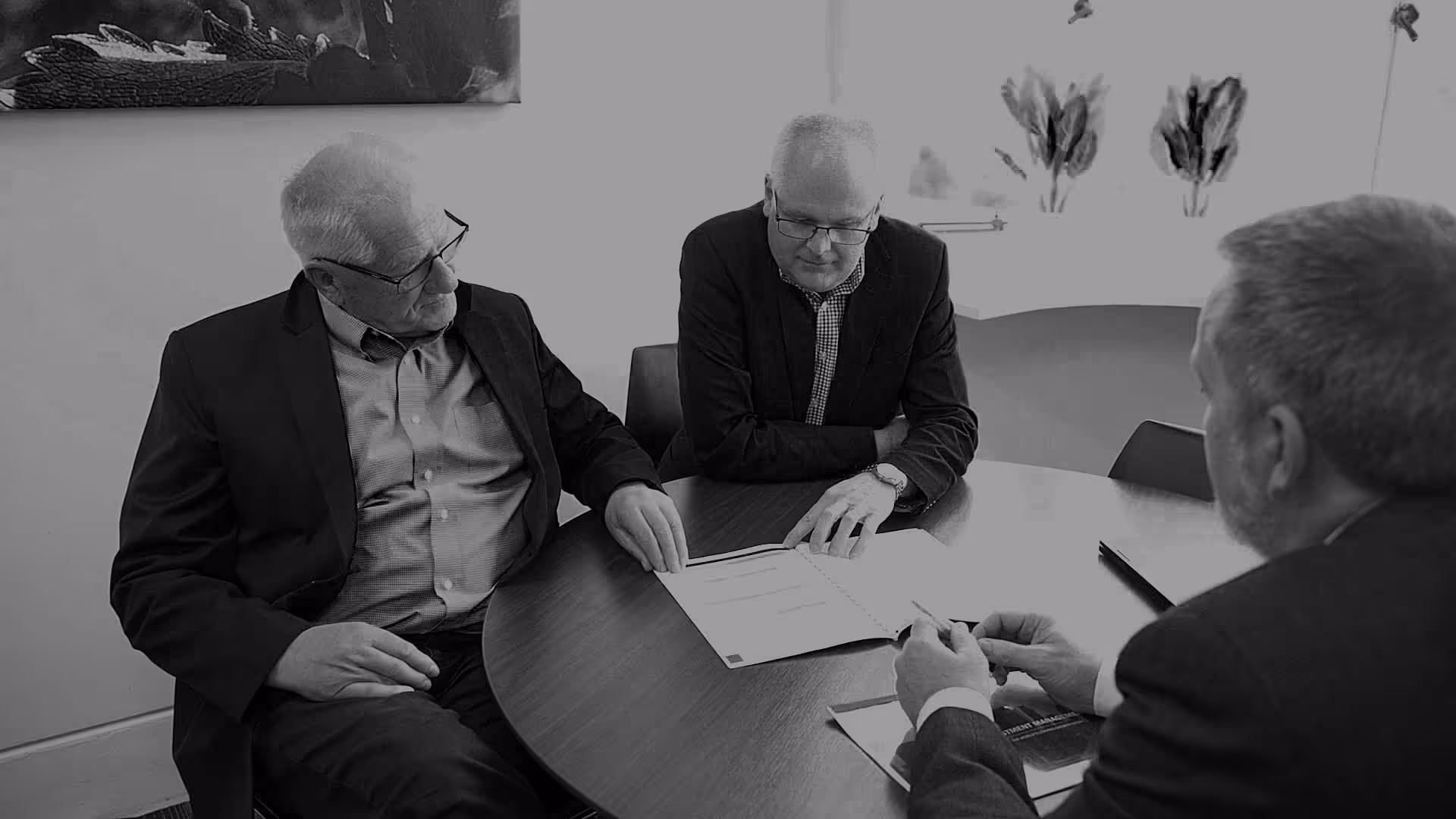 The Strategic team meeting around a table at their offices