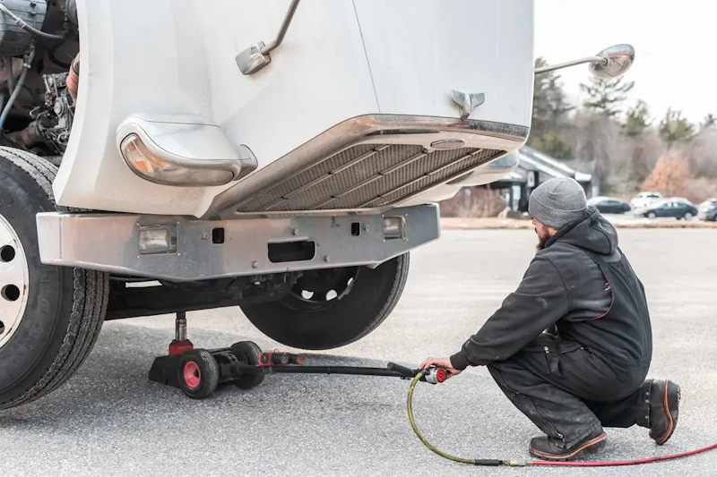 mobile mechanic raising a truck on a jack