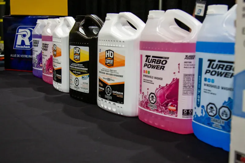 Oil and fluid products for heavy-duty vehicles displayed on a counter, including HD Expert and Turbo Power containers.