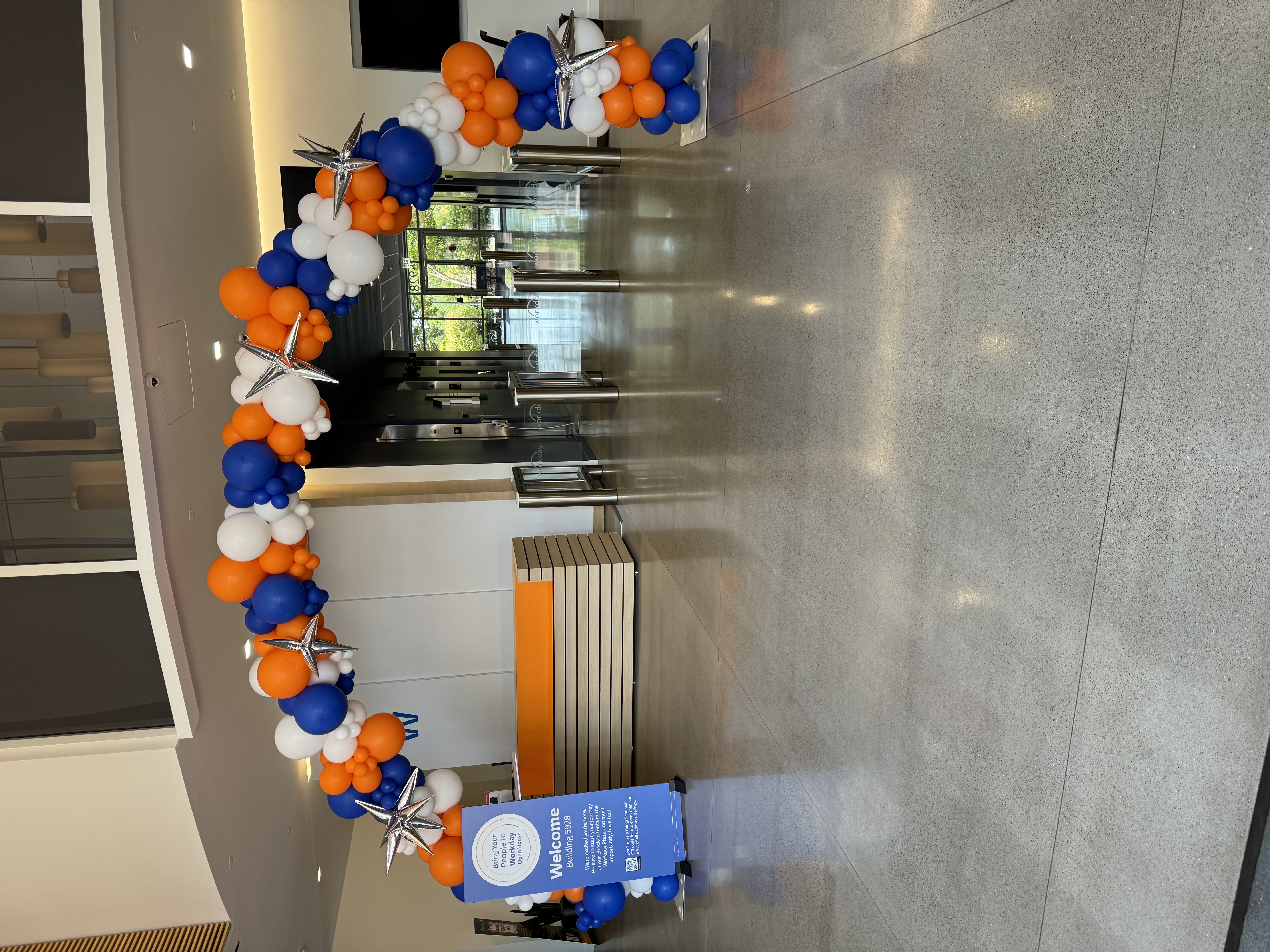 Corporate entrance arch with polished balloon decor by Poptastic Parties