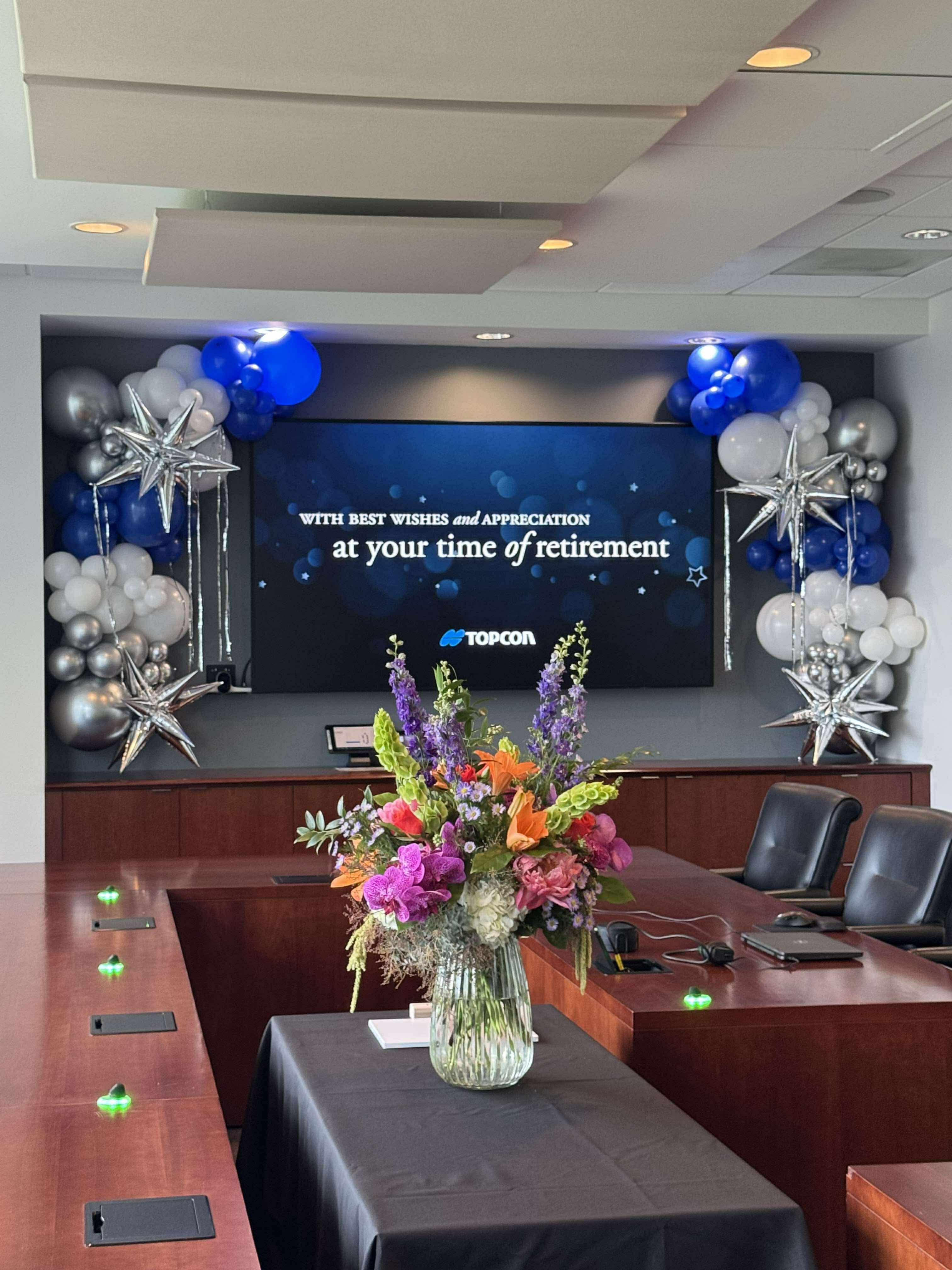 Corporate boardroom branded backdrop with balloon decor by Poptastic Parties