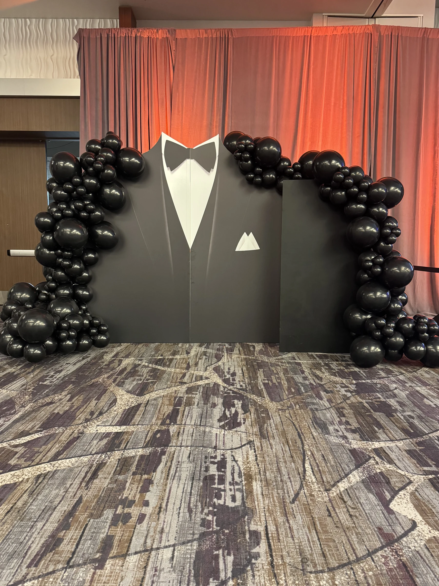 Black-tie photo backdrop by Poptastic Parties