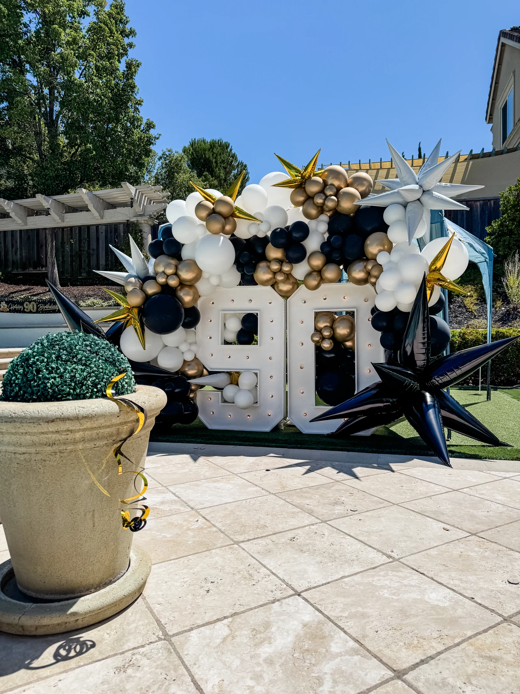Black and gold 90th birthday by Poptastic Parties