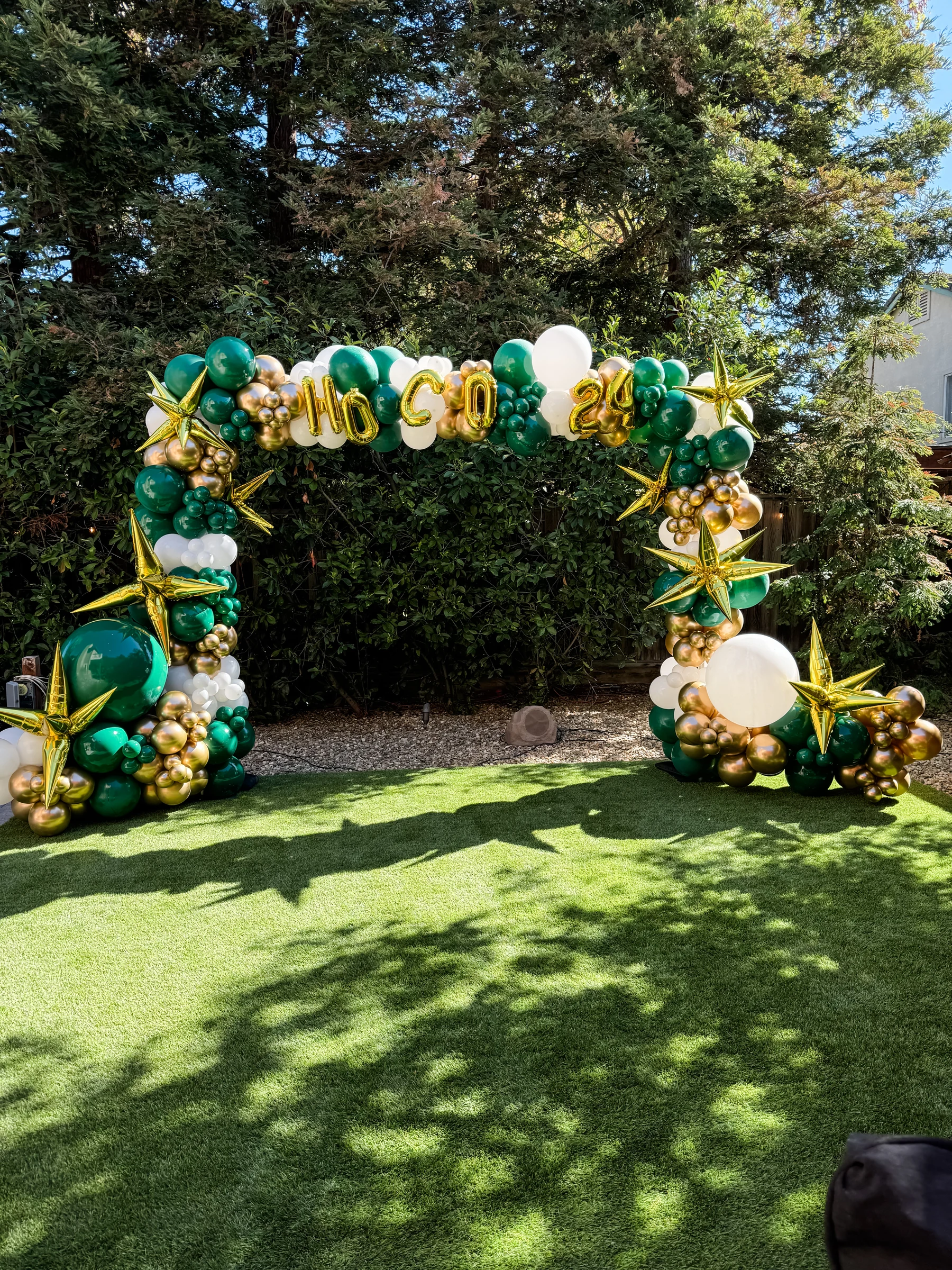 Green and gold homecoming arch by Poptastic Parties