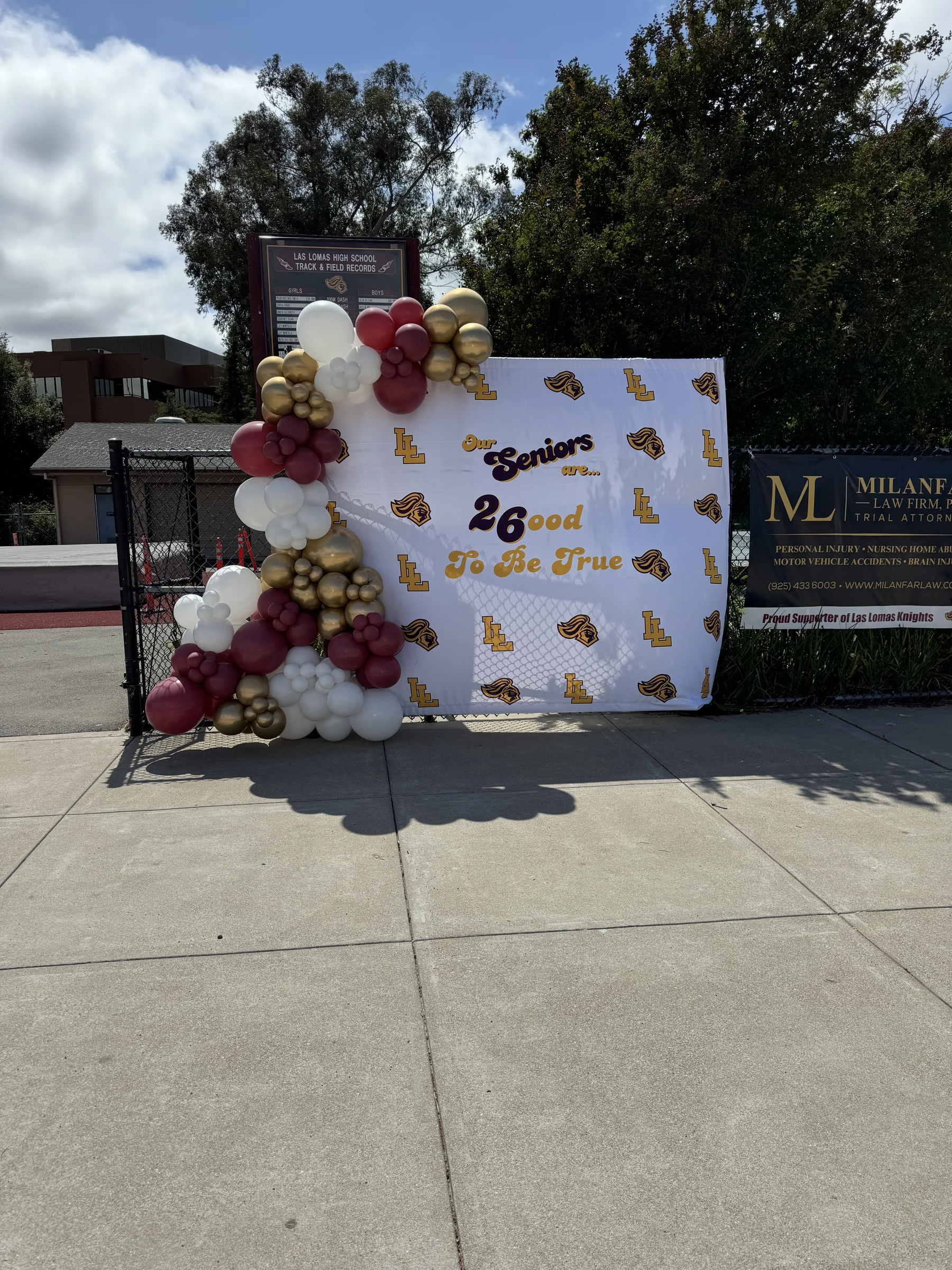 Maroon and gold seniors backdrop by Poptastic Parties