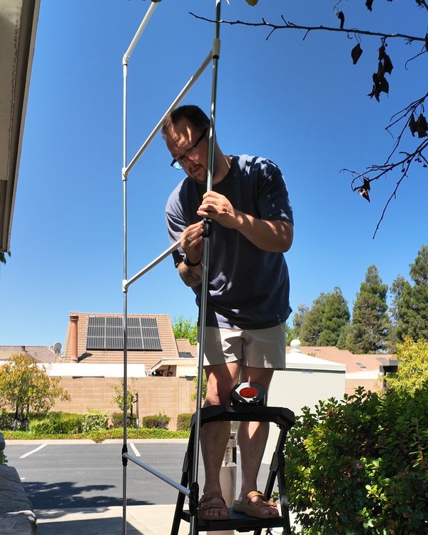 Kyle on a step ladder outside our Pleasanton studio taping the joints of the metal and PVC tower frame for the Golden Gate Bridge balloon sculpture